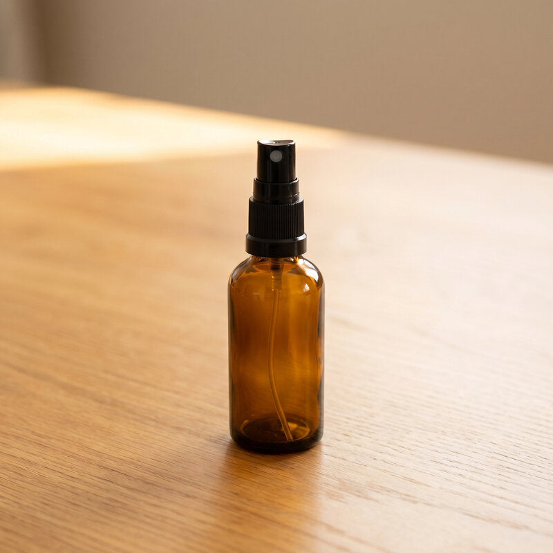 50ml Amber Glass Bottle with Black Mister Spray on warm timber surface
