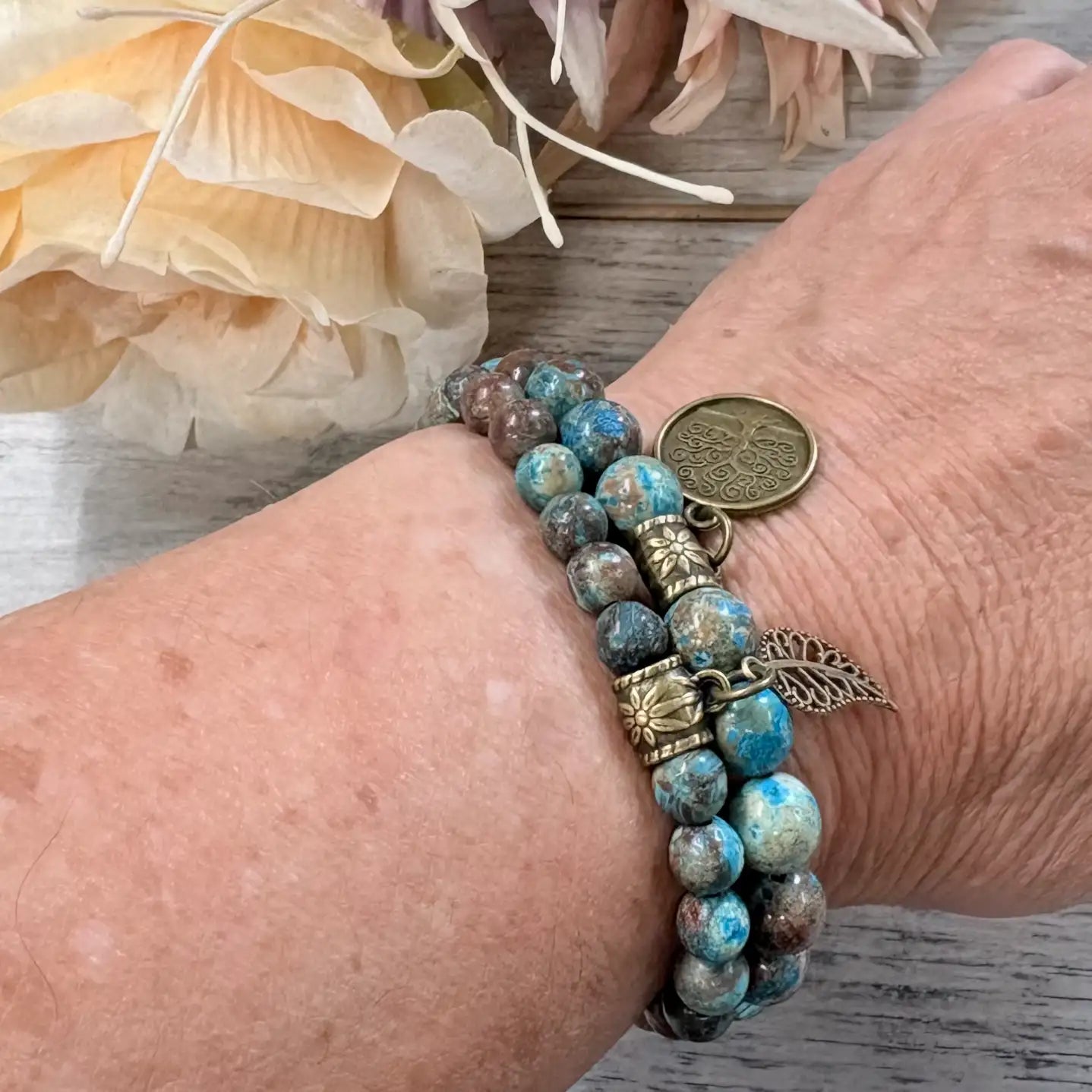 Natural aqua and brown beaded stretch bracelet on wrist