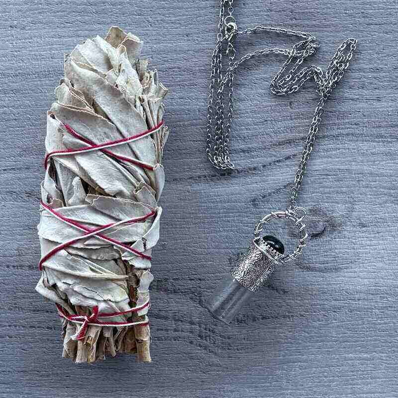 Clear glass roller with ornate silver lid with black onyx crystal stone & silver chain necklace pictured with sage smudge stick