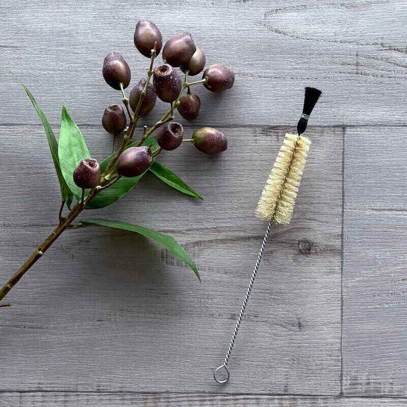 Conical brush with natural bristles and twisted wire handle