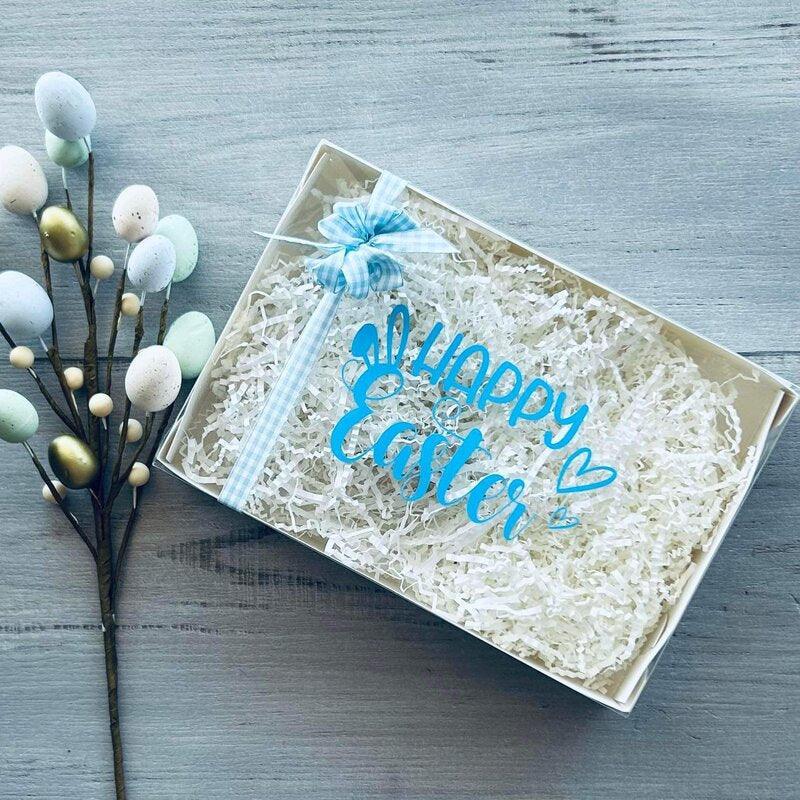 white hamper with clear lid and happy easter decal blue on lid white fill and blue ribbon