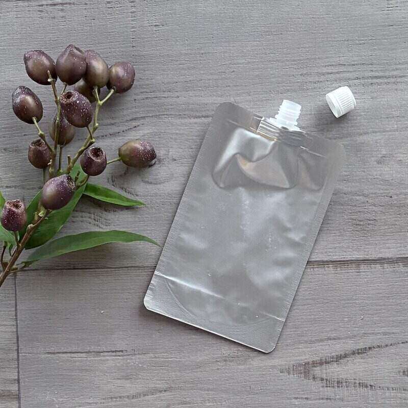 stand up Aluminium foil pouch with top spout 500ml capacity tamper evident lid off next to pouch