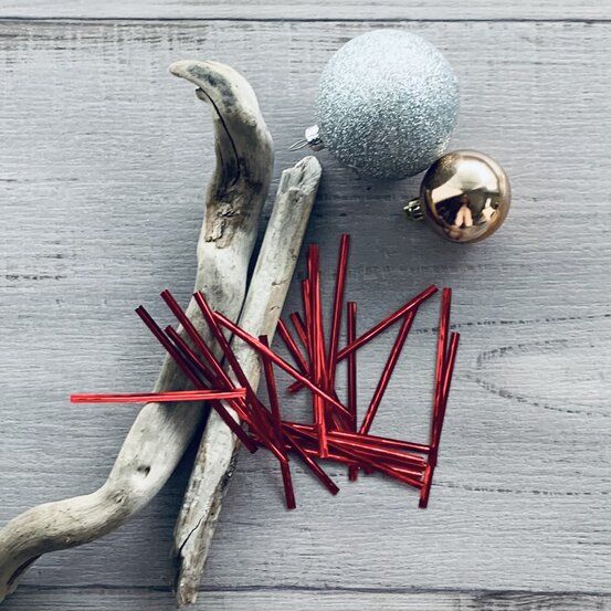 Red metallic twist ties with flexible wire inners for closing cellophane bags, paper bags and homemade treat packaging.