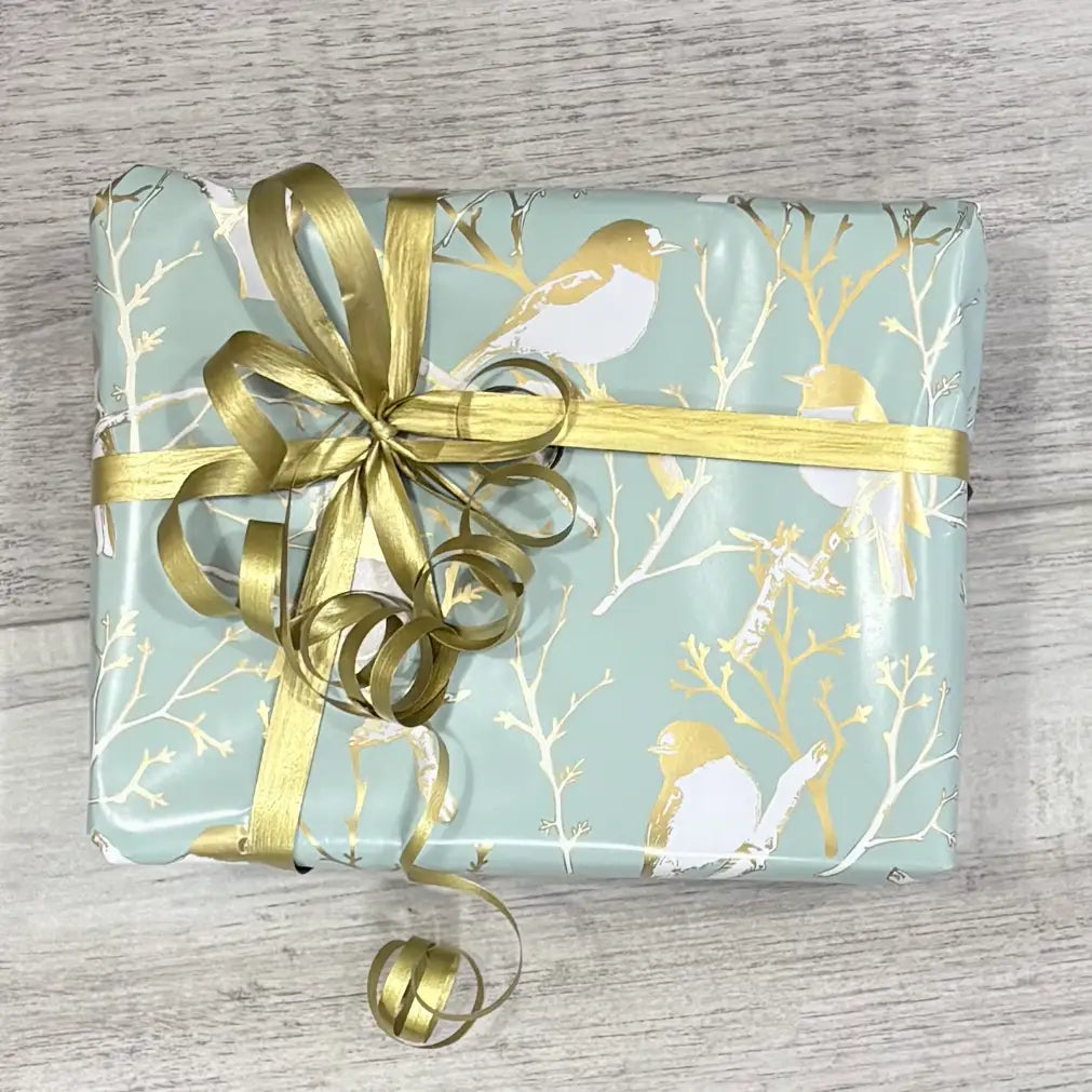 river gum robin wrapping paper with gold curling ribbon on box