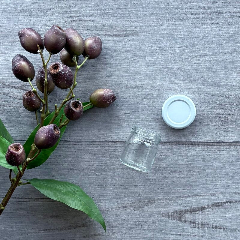 40ml clear glass jar with white metal lid next to jar