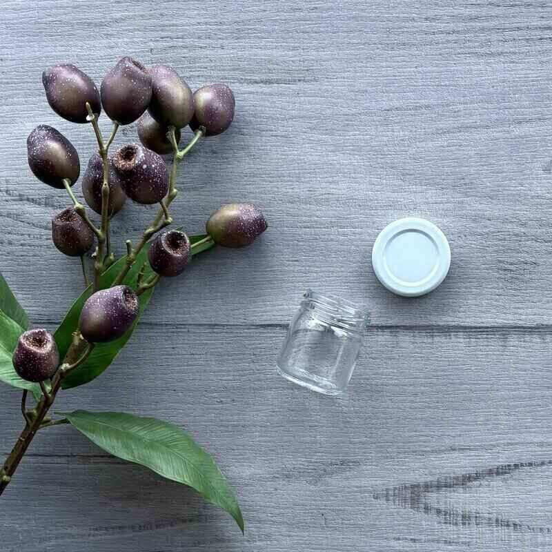 40ml clear glass jar with white metal lid next to jar