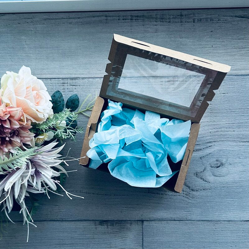 light blue tissue paper in kraft lunch box hamper