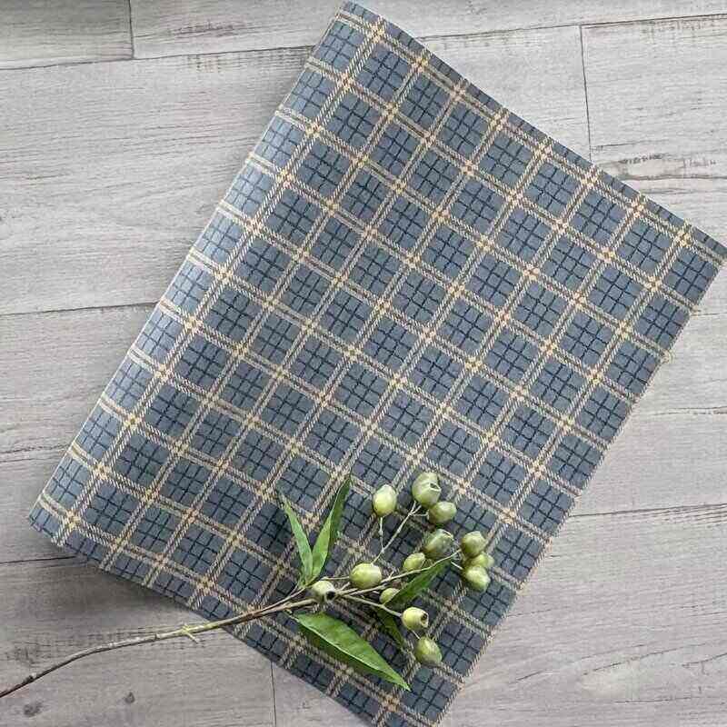 Classic plaid navy kraft wrapping paper, 80gsm, supplied in a 600mm wide by 40-metre bulk counter roll for gift wrapping and retail packaging.
