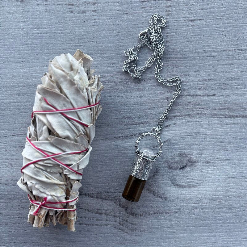 Amber glass roller with ornate silver lid with rose quartz crystal stone & silver chain necklace pictured with sage smudge stick
