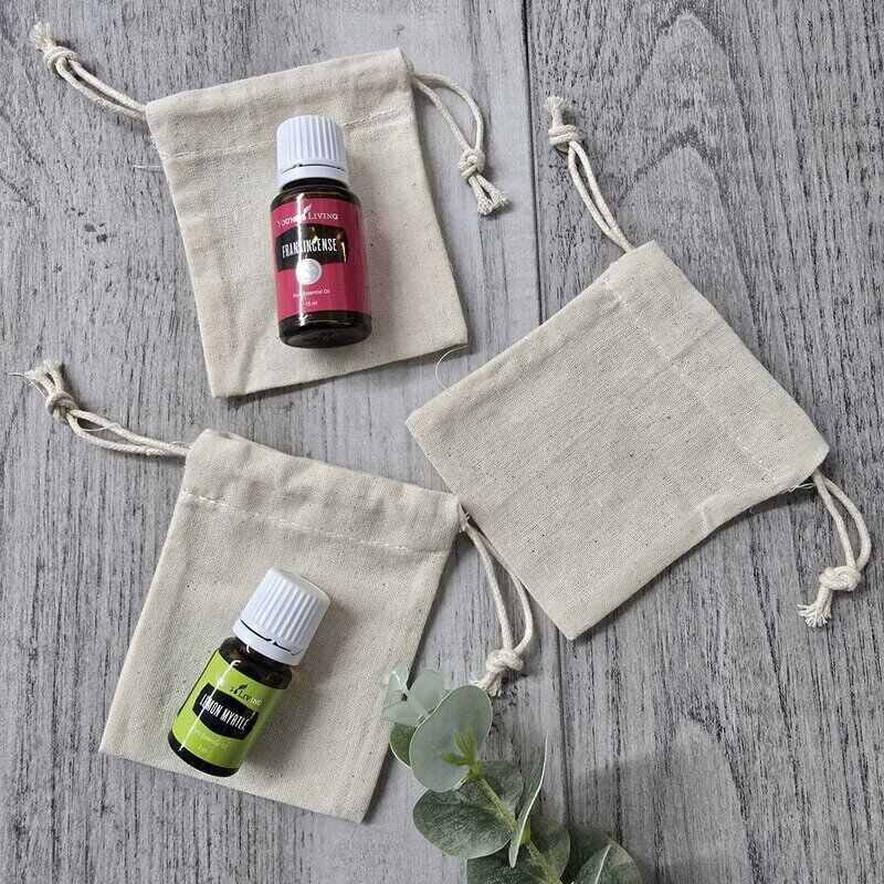 tiny calico bag x 3 with essential oil bottles on top
