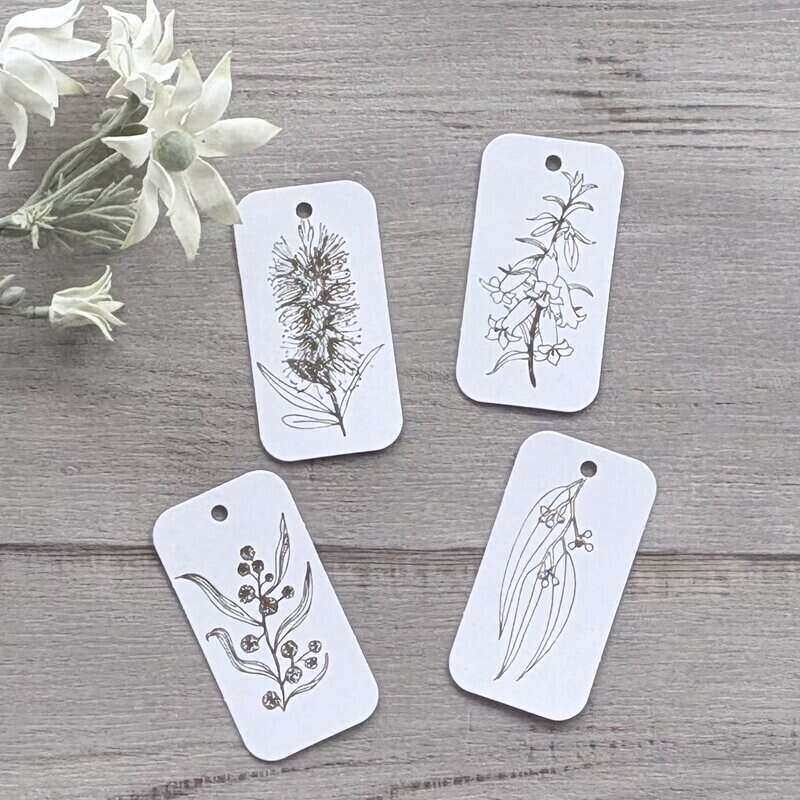 White cardboard botanical gift tags with gold printing, featuring bottlebrush, wattle, gum leaf and honeysuckle designs, supplied in a pack of 20.