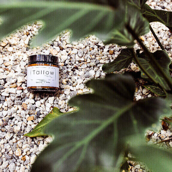 tallow by healthmade 100ml amber jar on rock bed plant