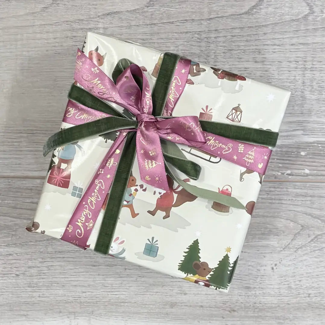 christmas friends wrapping paper with green velvet ribbon and plum merry christmas ribbon