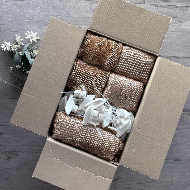 workshop box 3 product wrapped in hex paper with white misters on top