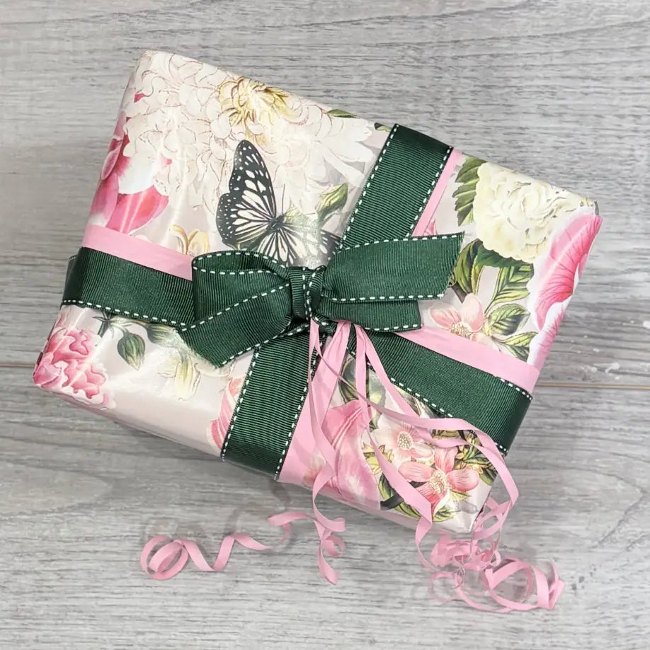 Wrapped box with Floral Butterfly wrapping paper and pink and dark green ribbon @ centaur packaging