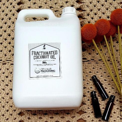 Bulk Fractionated Coconut Oil- 5lt - next to the bottle is 3 rollers amber glass