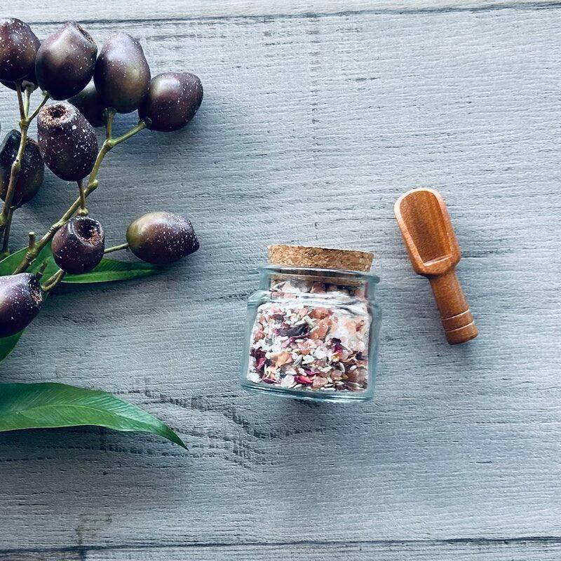 110ml clear jar with cork lid filled with bath salts and wooden scoop