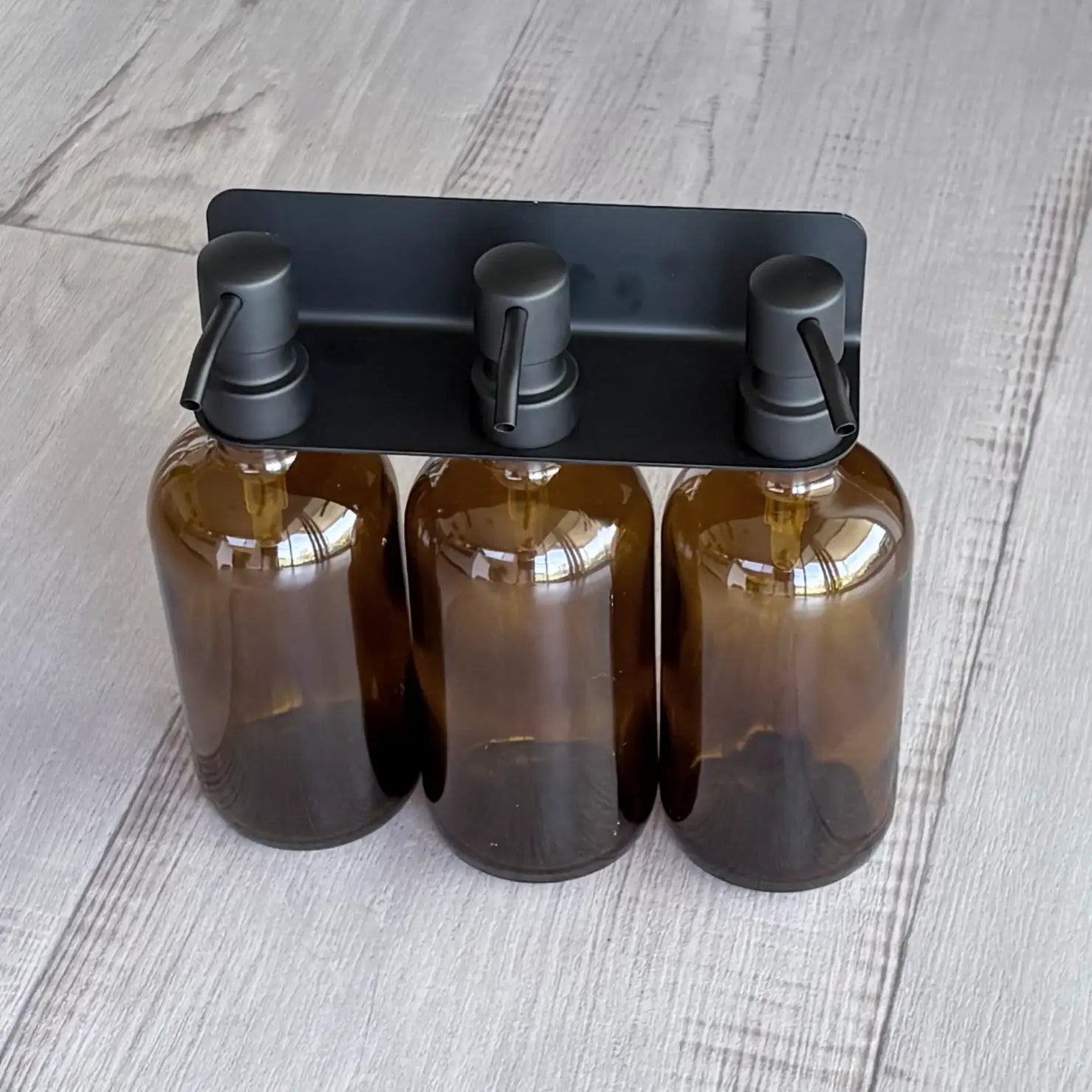 Stainless Steel 304 Soap Bottle Bracket 3 Hole – Black with tree amber bottles and black pumps