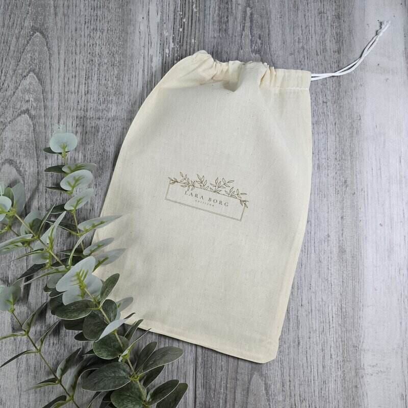 Beige drawstring bag with a brand logo 