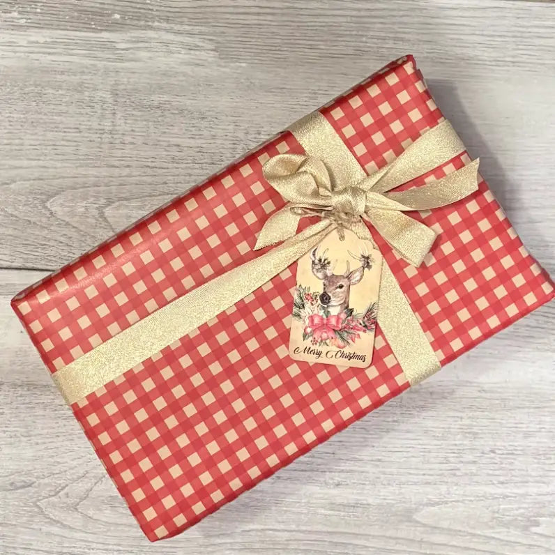 red and kraft gingham wrapping paper with gold ribbon and deer gift tag