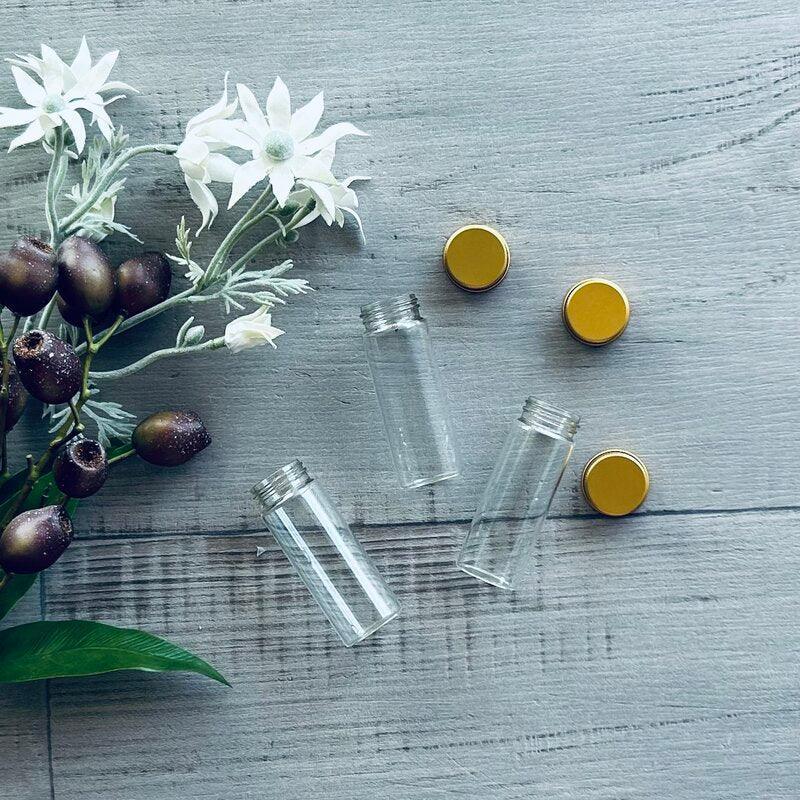 glass test tube with gold aluminium lid