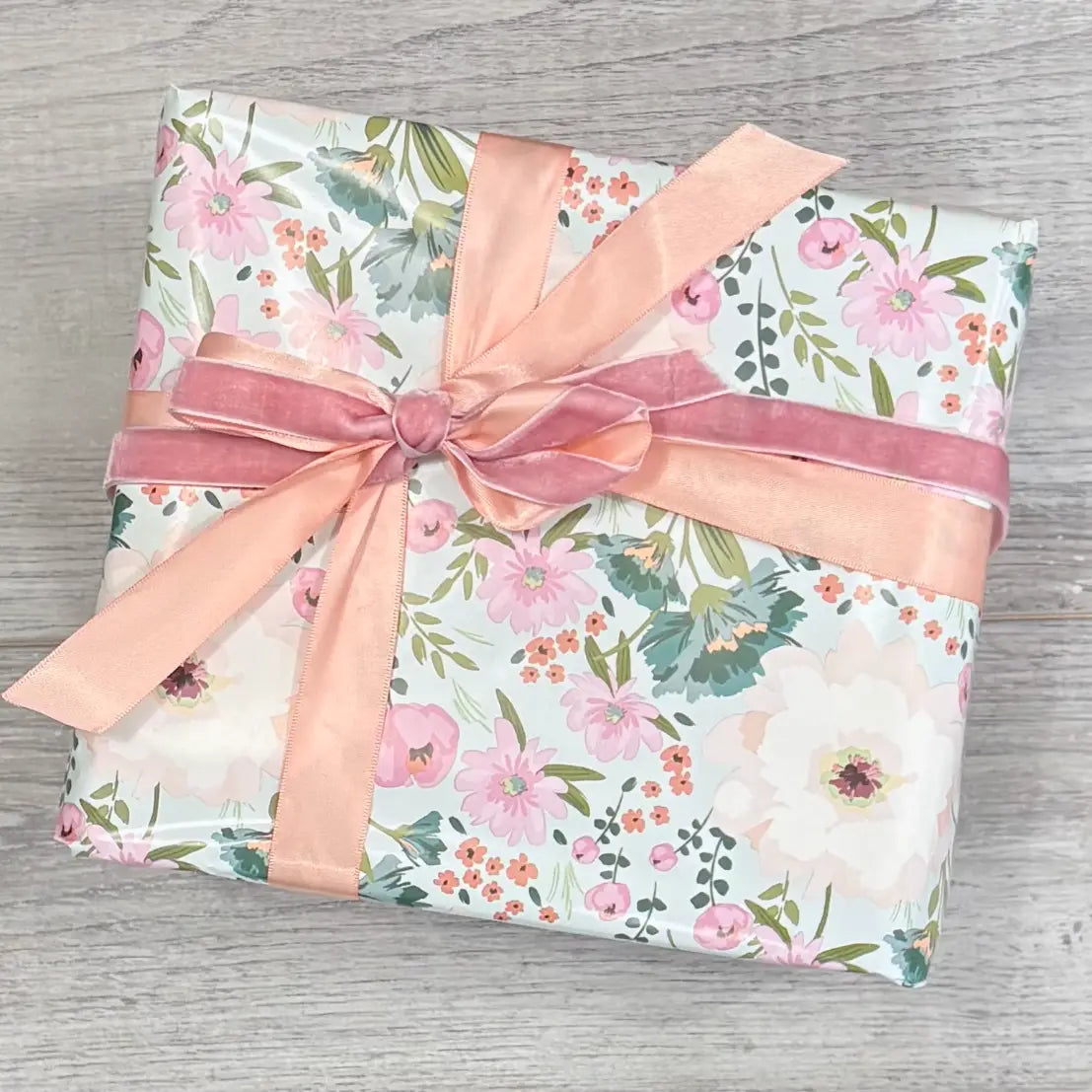 mint green floral wrapping paper on box with peach satin ribbon and pink velvet ribbon