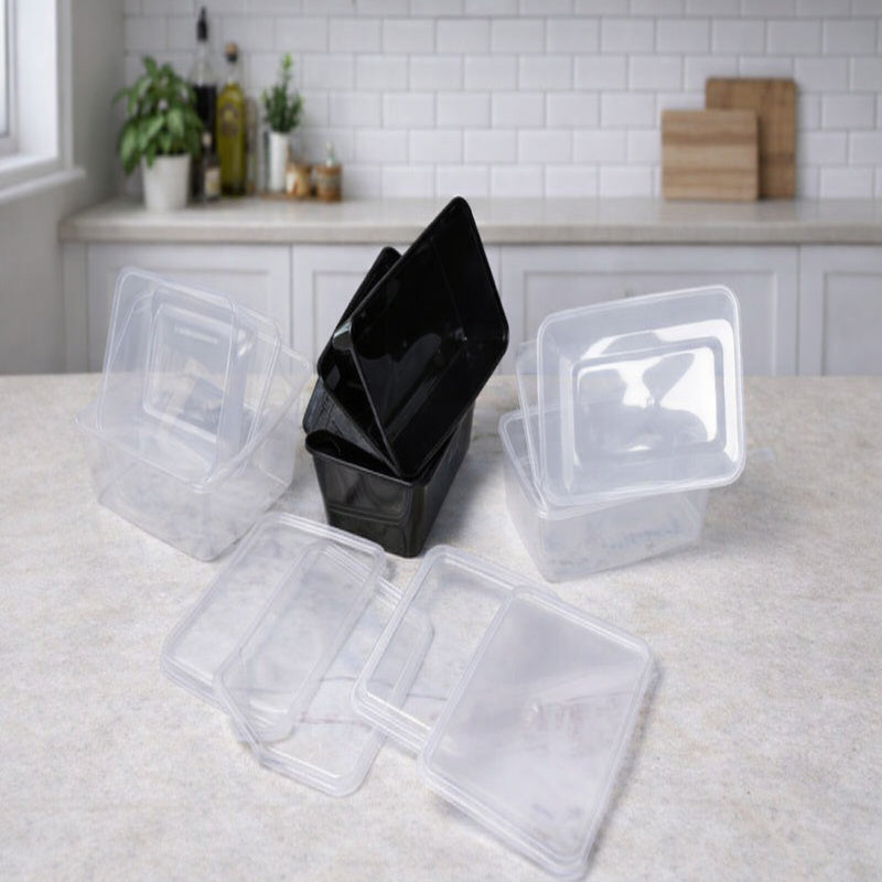 Clear plastic food containers with black bin on a kitchen counter