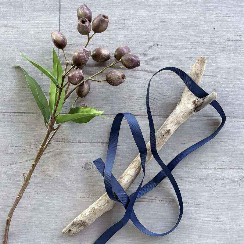Navy grosgrain ribbon with a distinctive ribbed texture, measuring 15mm wide and 30 metres long, suitable for gift wrapping and craft projects.