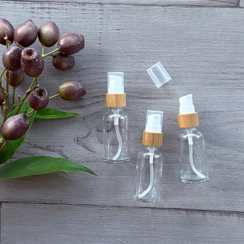 30ml clear glass bottle with bamboo pump x 3 one with cap off