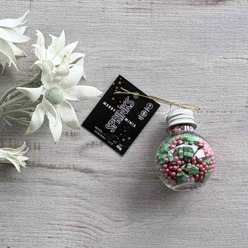 SPRINKS Merry Minis Merry & Bright Christmas bauble with JOY lettering, filled with red berry and green holly leaf sprinkles.