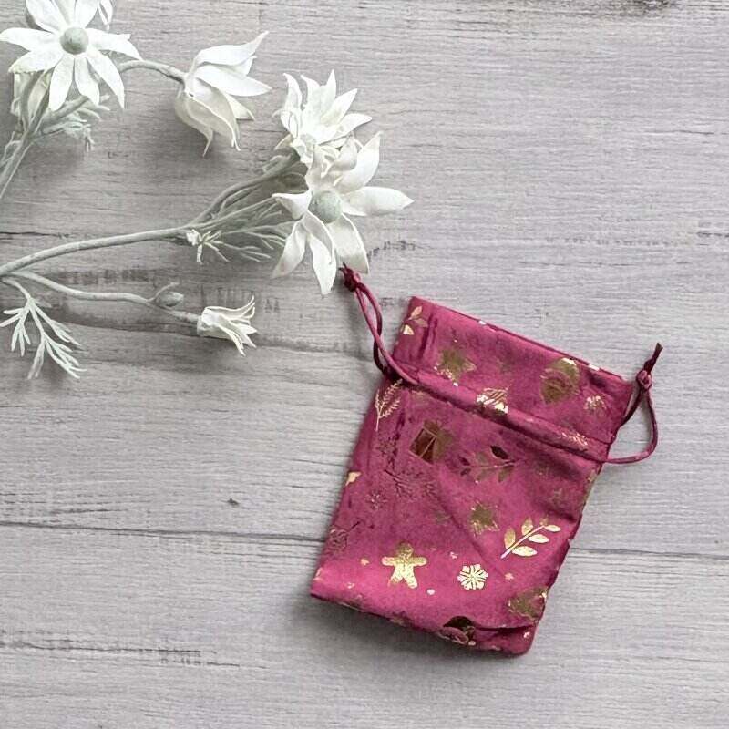Small red velvet Christmas gift bag decorated with gold motifs, measuring 10 x 12.5cm, for festive gift presentation.