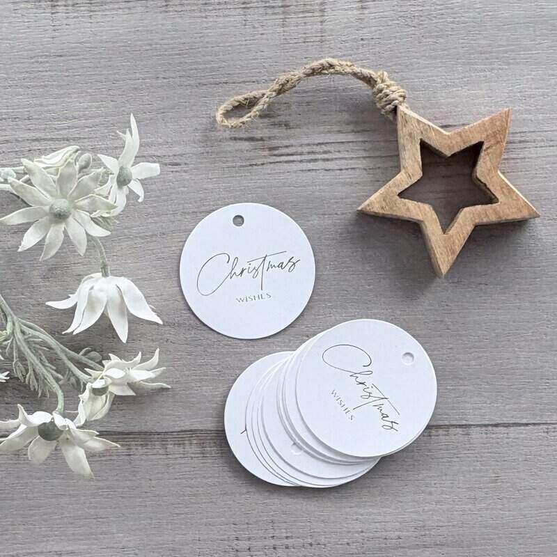 Round white cardboard Christmas gift tags printed with silver Christmas wishes, featuring a hanging hole for ribbon or twine, supplied in a pack of 20.