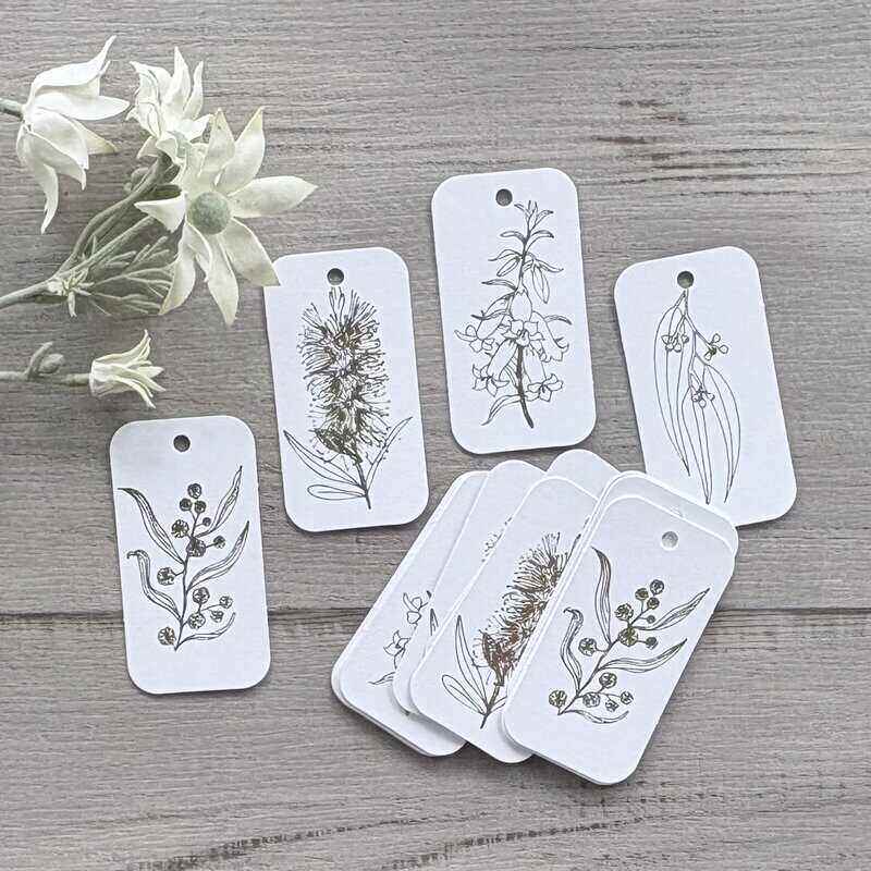 White cardboard botanical gift tags with gold printing, featuring bottlebrush, wattle, gum leaf and honeysuckle designs, supplied in a pack of 20.