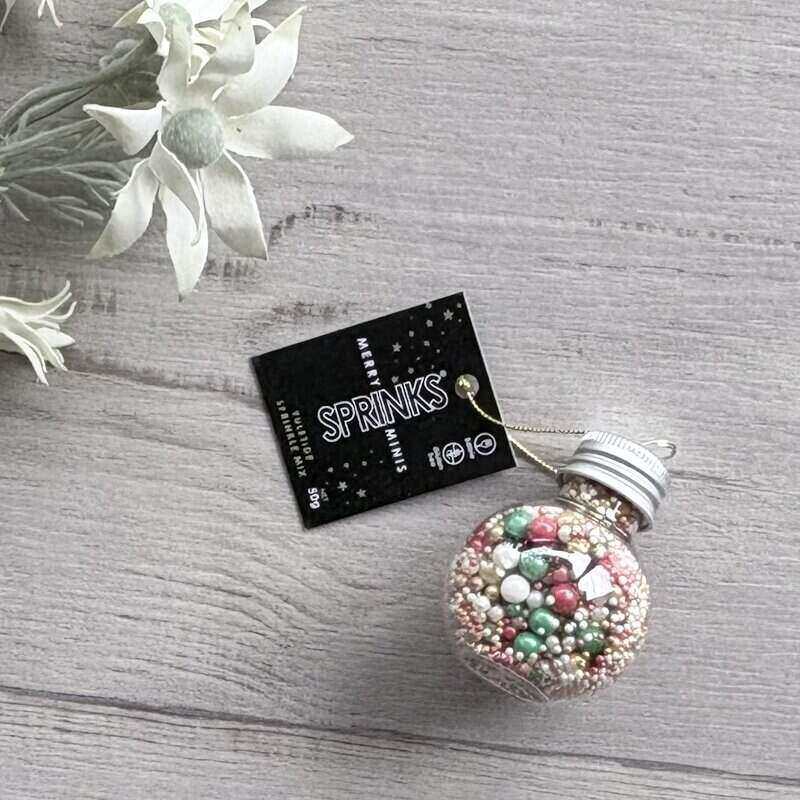 SPRINKS Merry Minis Yuletide Mix Christmas bauble with JOY lettering, filled with red, gold, pearl and green lustre sprinkle pearls.