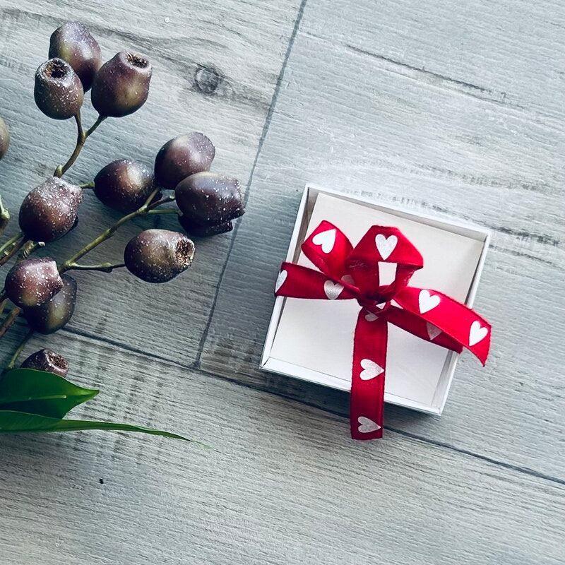singe white cookie box with clear lid and red  and white heart ribbon