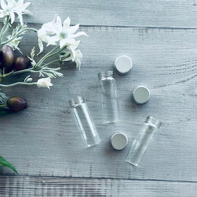 glass test tube with silver lid three together