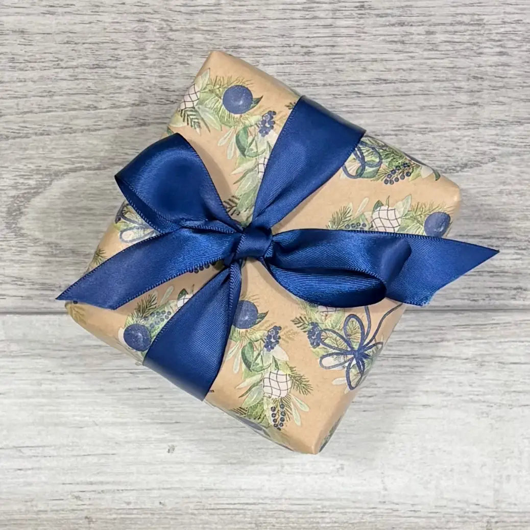 wreath wrapping paper with navy satin ribbon